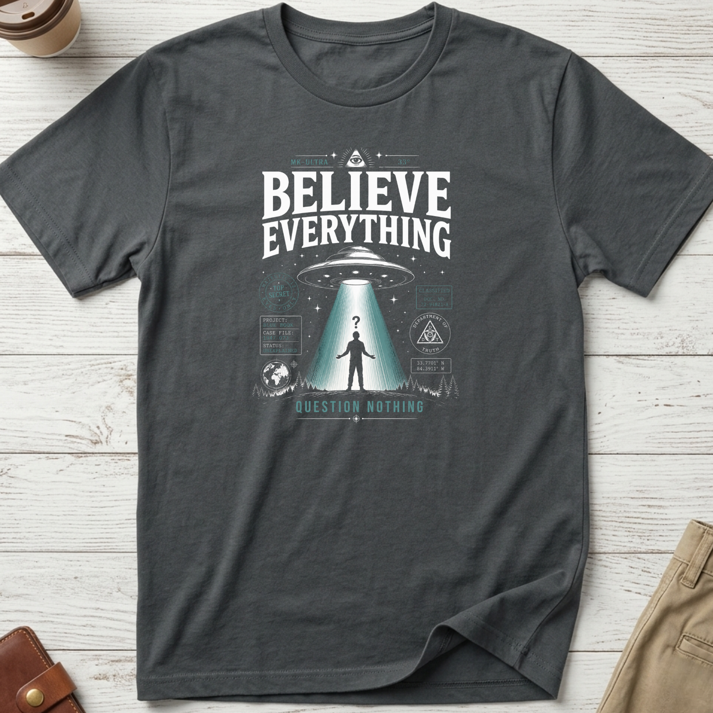 Believe Everything Question Nothing graphic t-shirt featuring vintage UFO abduction artwork with conspiracy-inspired design on charcoal unisex tee.