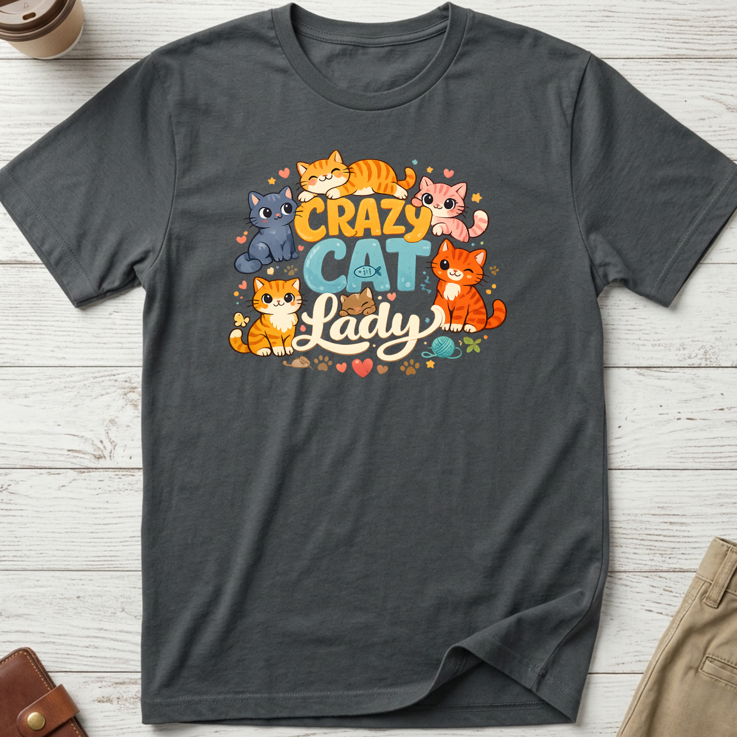 Crazy Cat Lady graphic t-shirt featuring colourful cartoon kittens and playful typography on a charcoal unisex tee.