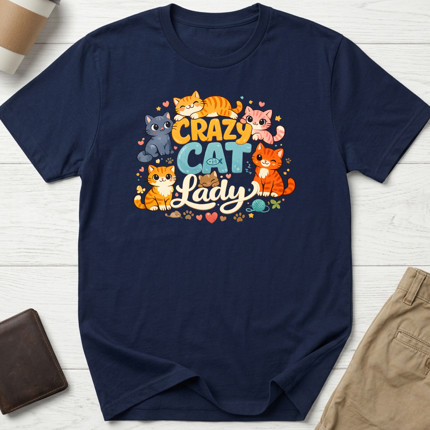 Crazy Cat Lady graphic t-shirt featuring colourful cartoon kittens and playful typography on a navy unisex tee.