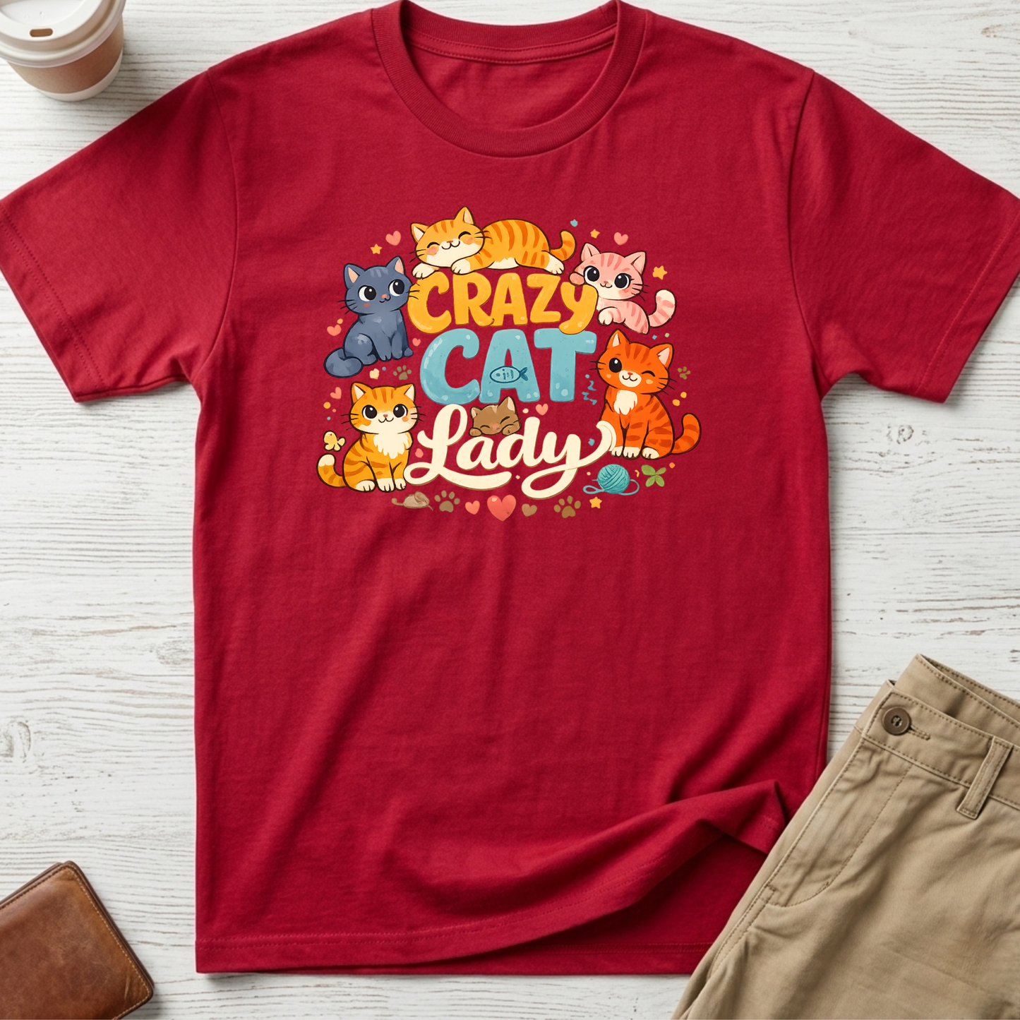 Crazy Cat Lady graphic t-shirt featuring colourful cartoon kittens and playful typography on a red unisex tee.