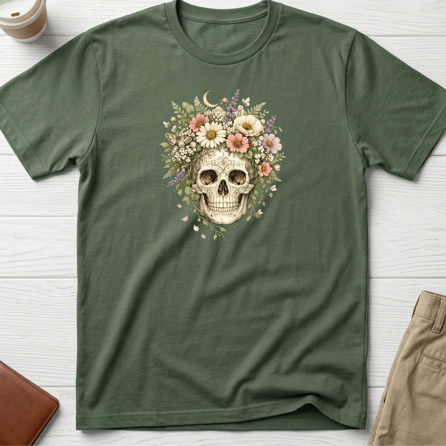 Floral Skull graphic t-shirt featuring a vintage skull surrounded by blooming wildflowers and botanical elements on a green unisex tee.