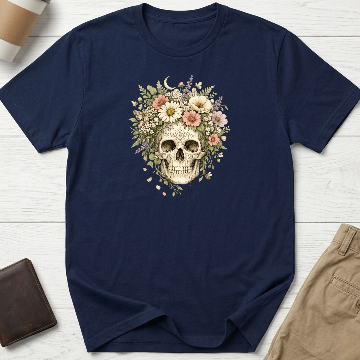 Floral Skull graphic t-shirt featuring a vintage skull surrounded by blooming wildflowers and botanical elements on a navy unisex tee.