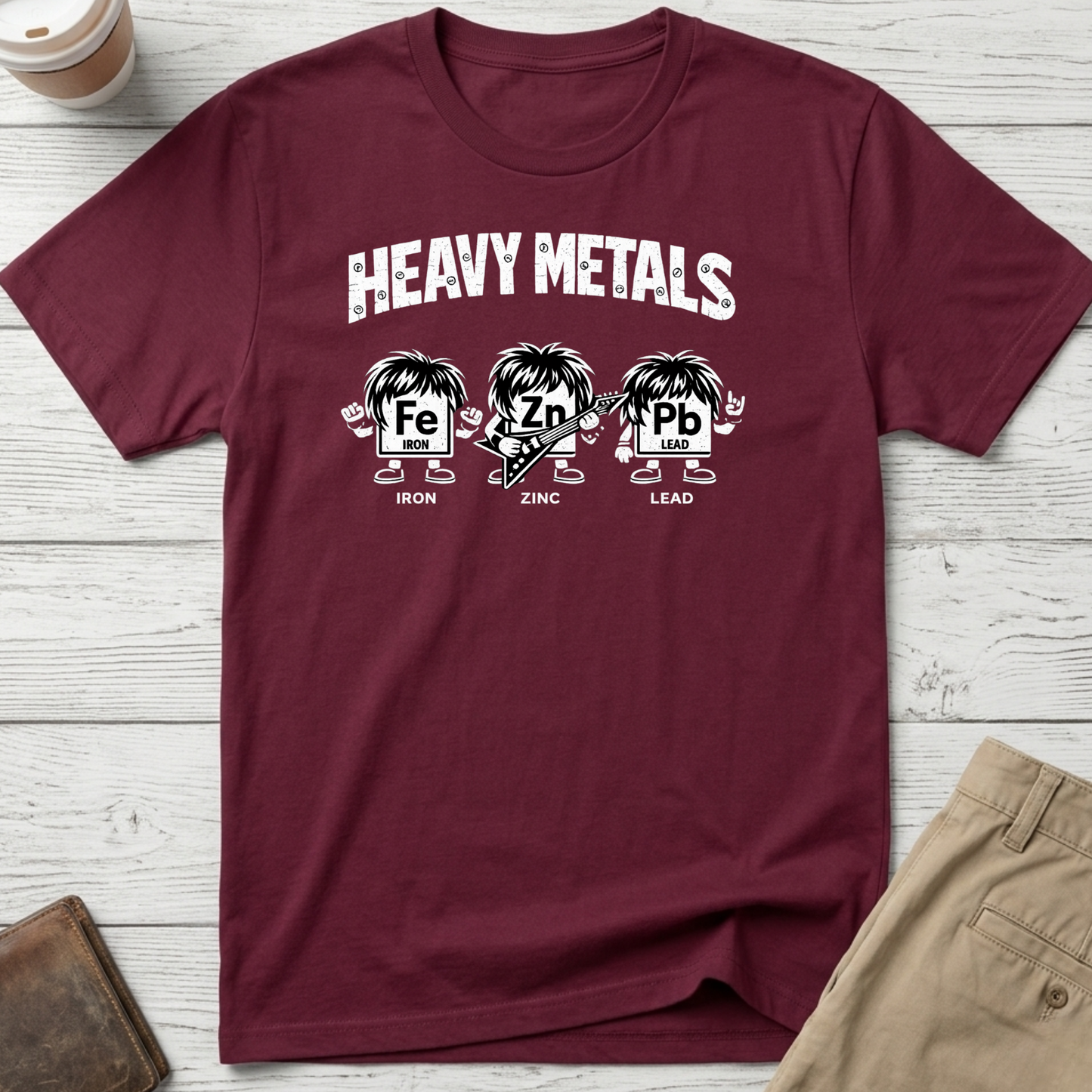 Heavy Metals funny graphic t-shirt featuring Iron, Zinc and Lead characters in a rock band parody design on maroon unisex tee.