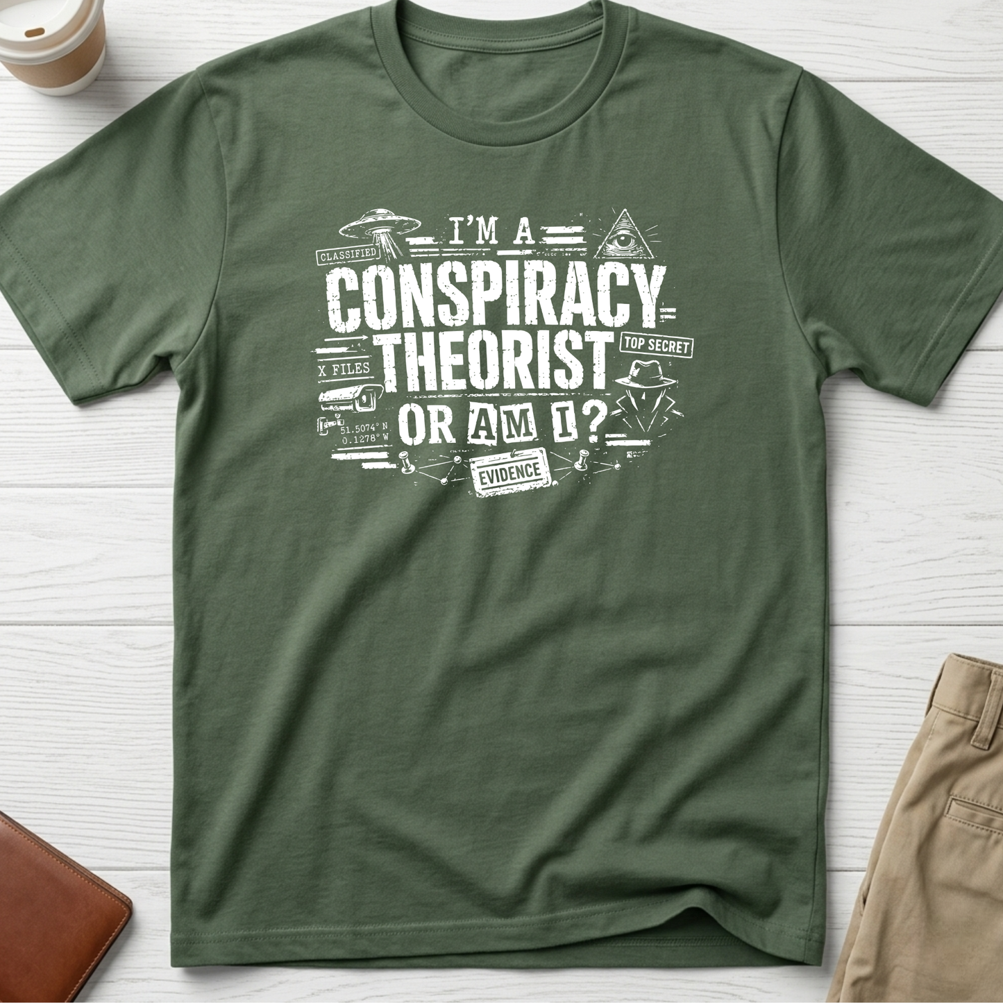 I'm A Conspiracy Theorist Or Am I graphic t-shirt featuring UFOs, classified files, secret agent artwork and distressed typography on a green unisex tee.
