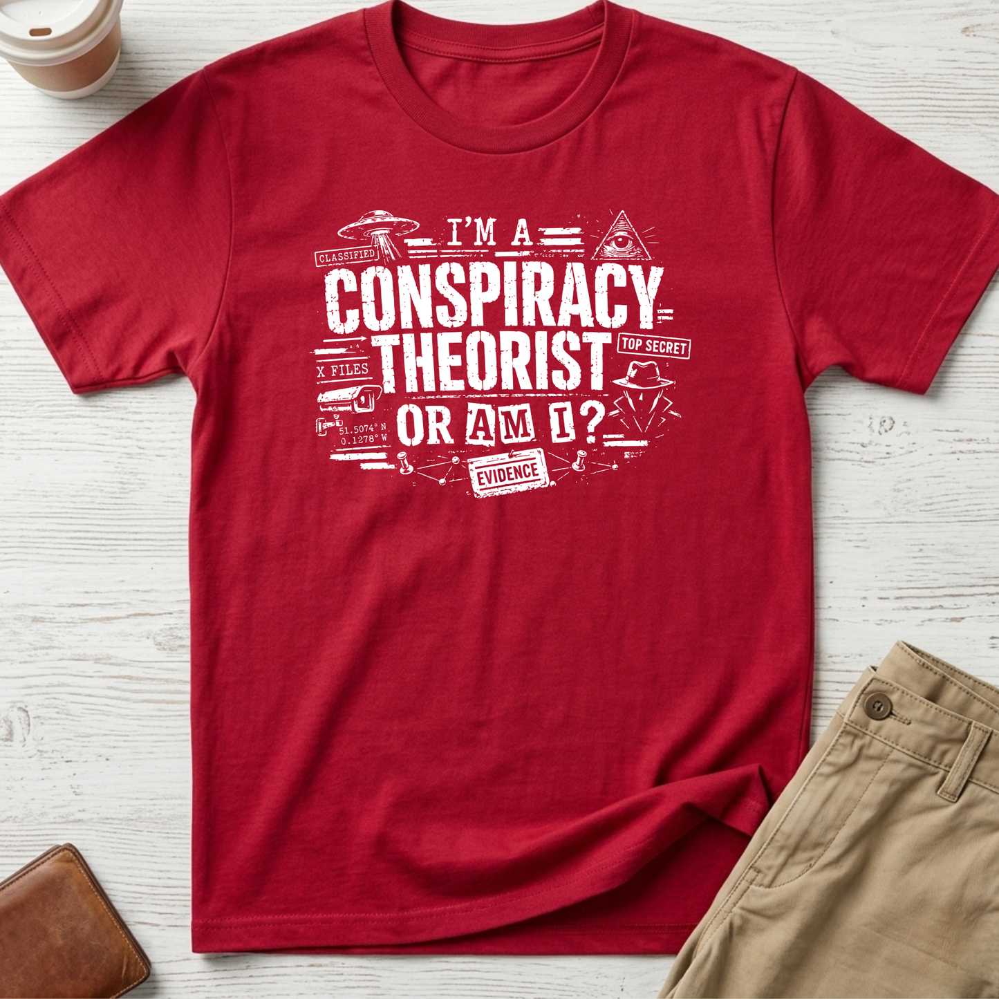 I'm A Conspiracy Theorist Or Am I graphic t-shirt featuring UFOs, classified files, secret agent artwork and distressed typography on a red unisex tee.