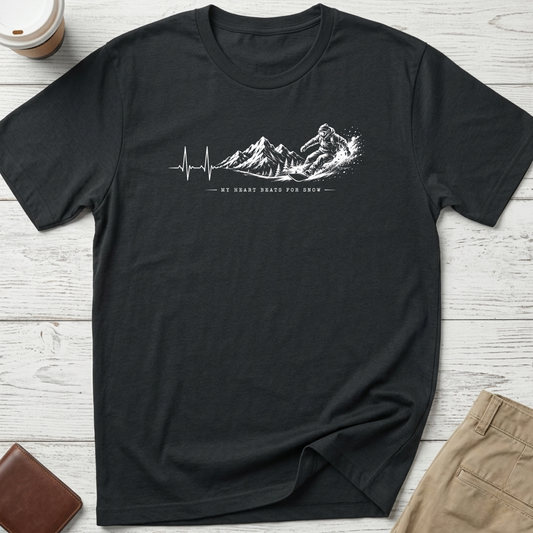 My Heart Beats for Snow graphic t-shirt featuring an ECG heartbeat transforming into mountain peaks with a snowboarder on a black unisex tee.