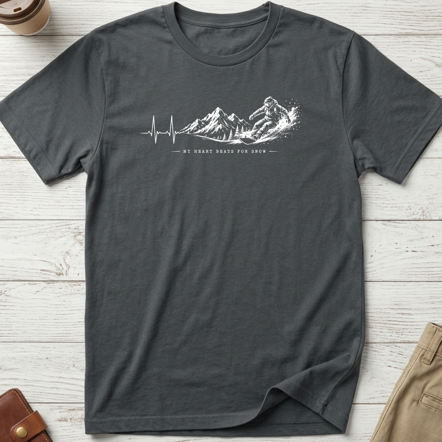 My Heart Beats for Snow graphic t-shirt featuring an ECG heartbeat transforming into mountain peaks with a snowboarder on a grey unisex tee.