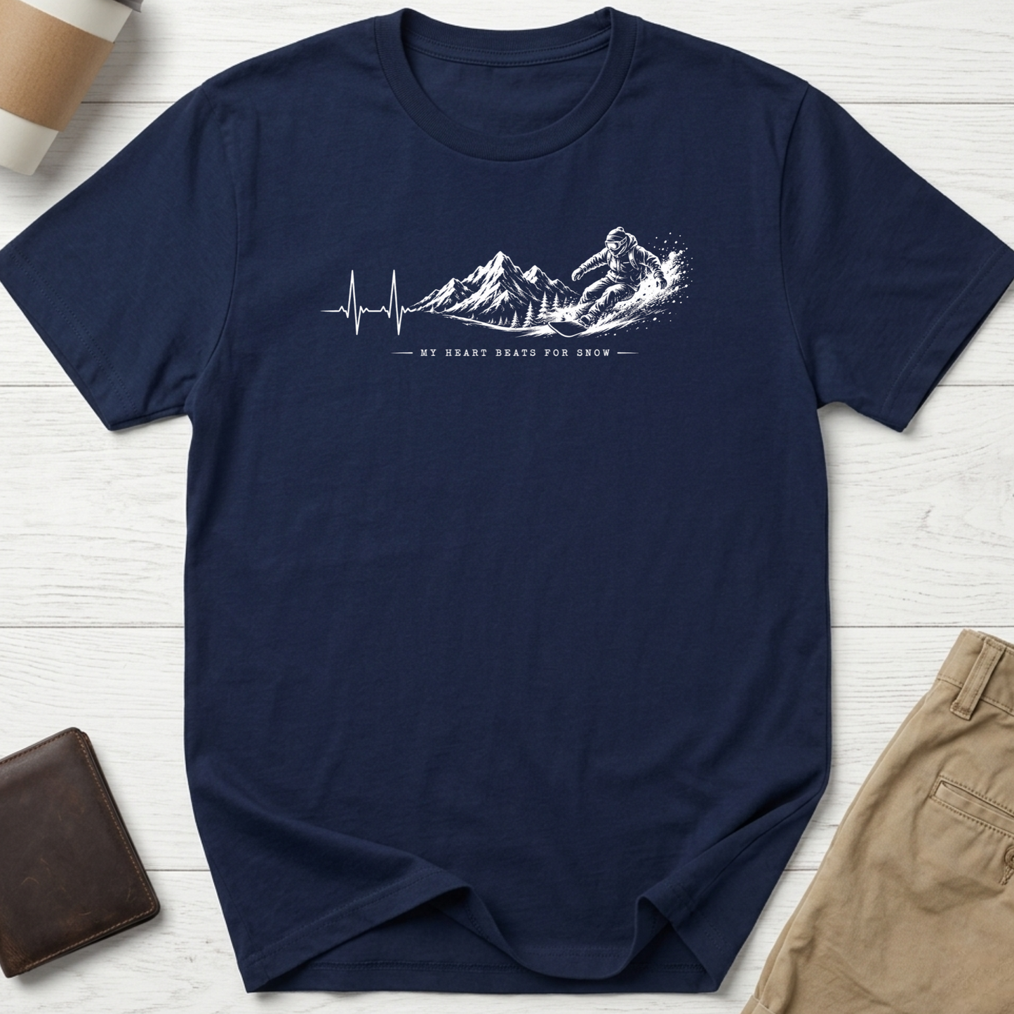 My Heart Beats for Snow graphic t-shirt featuring an ECG heartbeat transforming into mountain peaks with a snowboarder on a navy unisex tee.