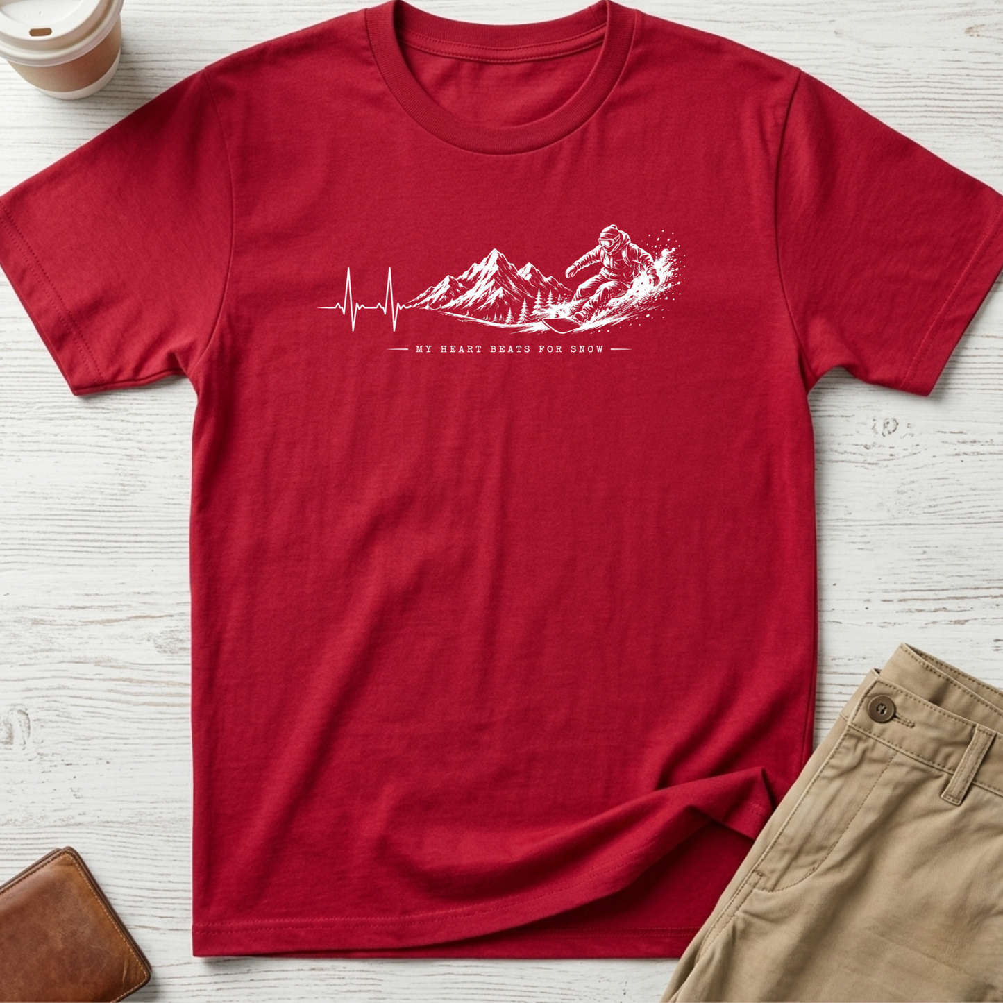 My Heart Beats for Snow graphic t-shirt featuring an ECG heartbeat transforming into mountain peaks with a snowboarder on a red unisex tee.