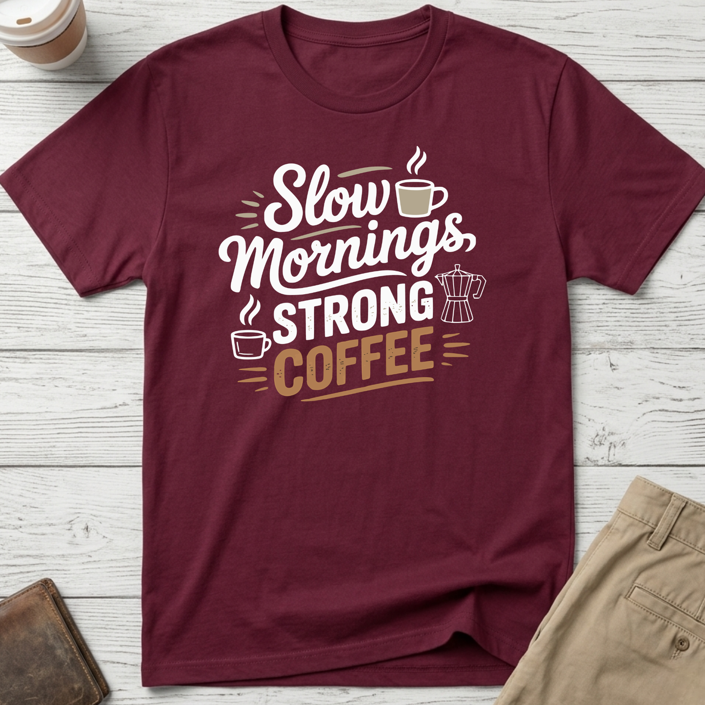 Slow Mornings Strong Coffee graphic t-shirt featuring stylish typography with coffee cup and moka pot illustration on maroon unisex tee.