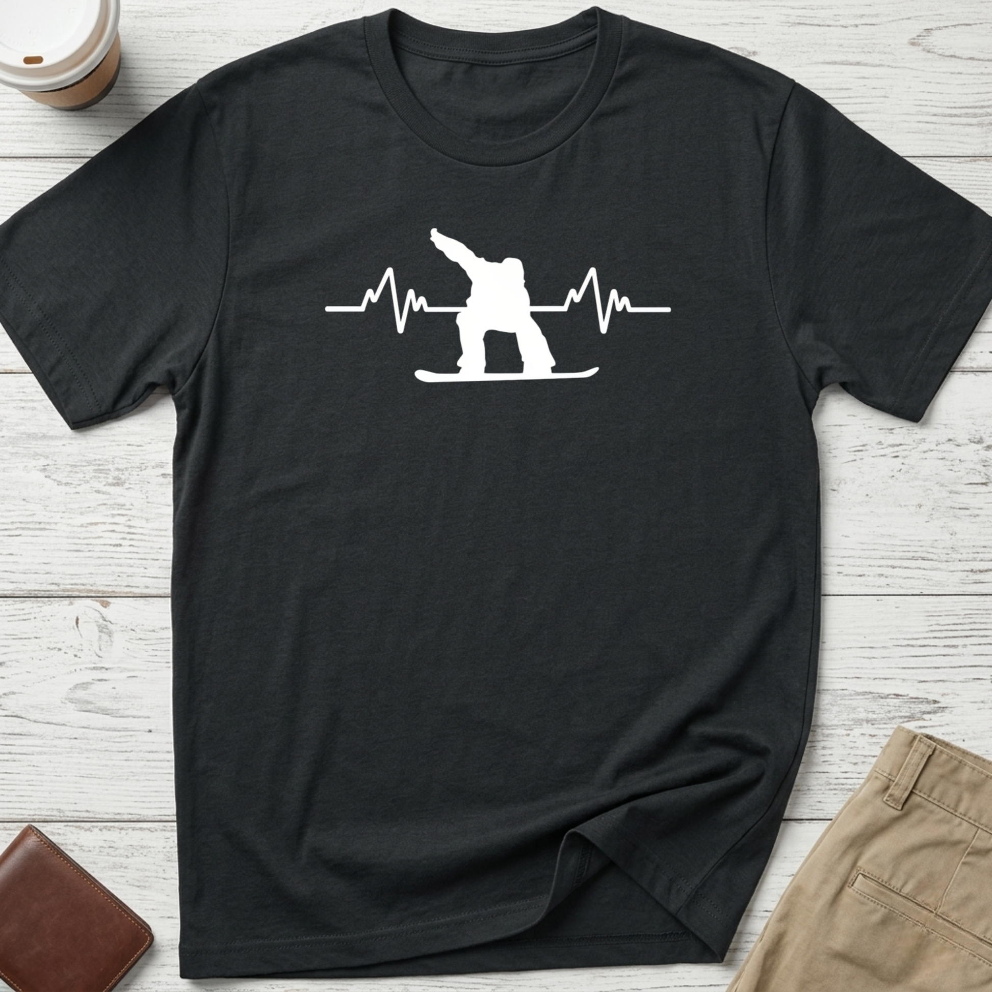 Snowboard Heartbeat graphic t-shirt featuring an ECG heartbeat line with a snowboarder silhouette on a black unisex tee.