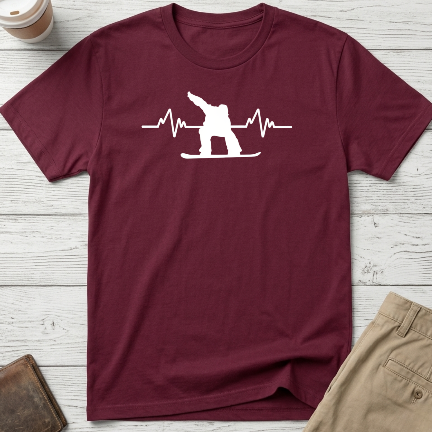 Snowboard Heartbeat graphic t-shirt featuring an ECG heartbeat line with a snowboarder silhouette on a maroon unisex tee.