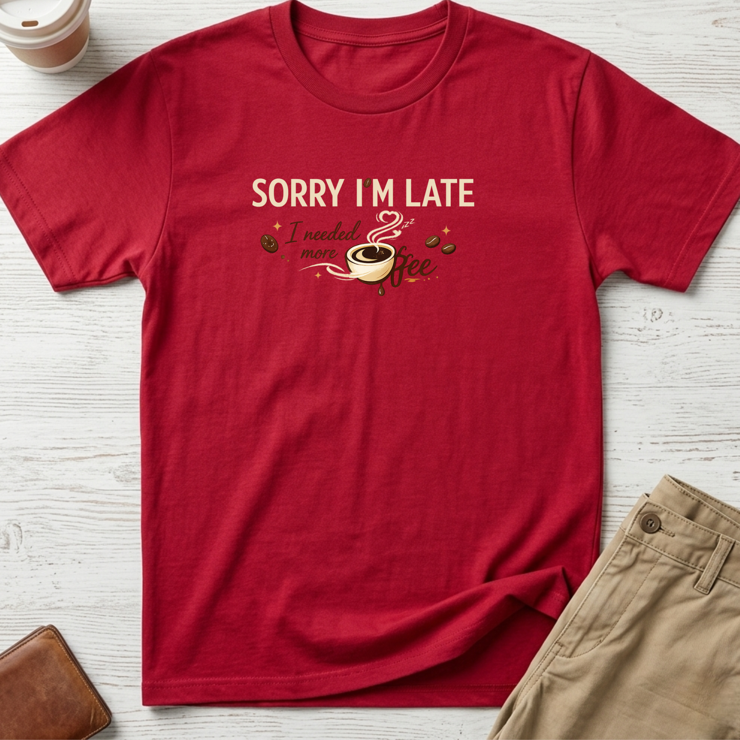Sorry I'm Late I Needed More Coffee graphic t-shirt featuring playful coffee quote and steaming coffee cup illustration on red unisex tee.