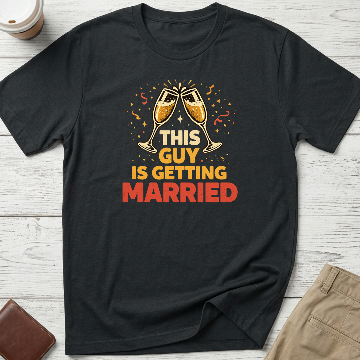 This Guy Is Getting Married graphic t-shirt featuring champagne glasses and bold celebration typography on a black unisex tee.