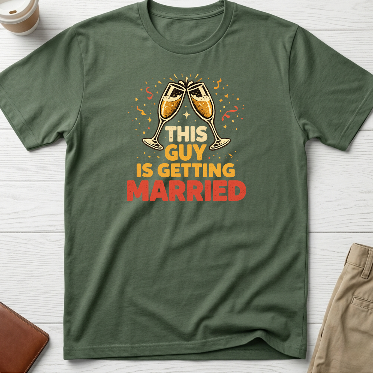This Guy Is Getting Married graphic t-shirt featuring champagne glasses and bold celebration typography on a green unisex tee.