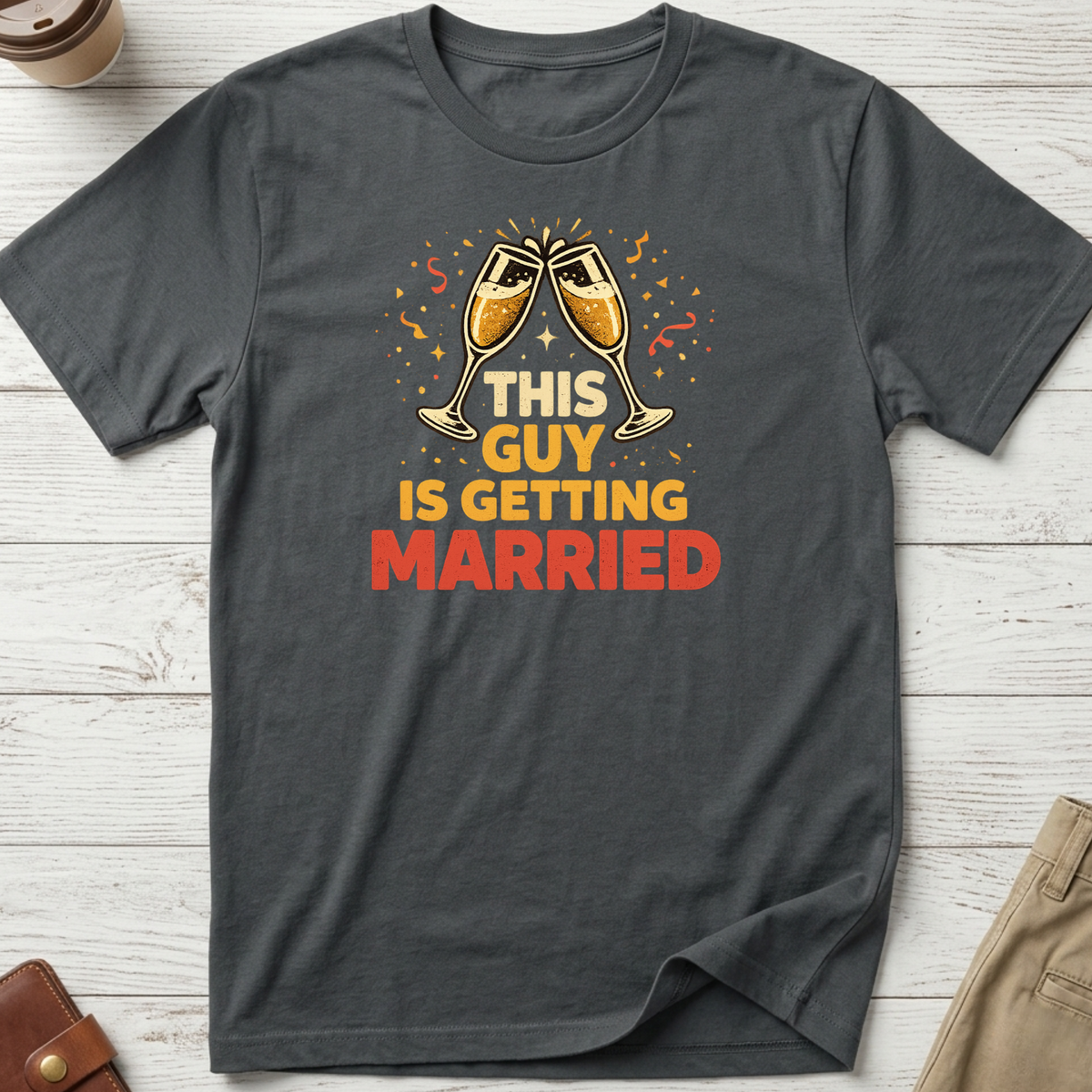 This Guy Is Getting Married graphic t-shirt featuring champagne glasses and bold celebration typography on a grey unisex tee.