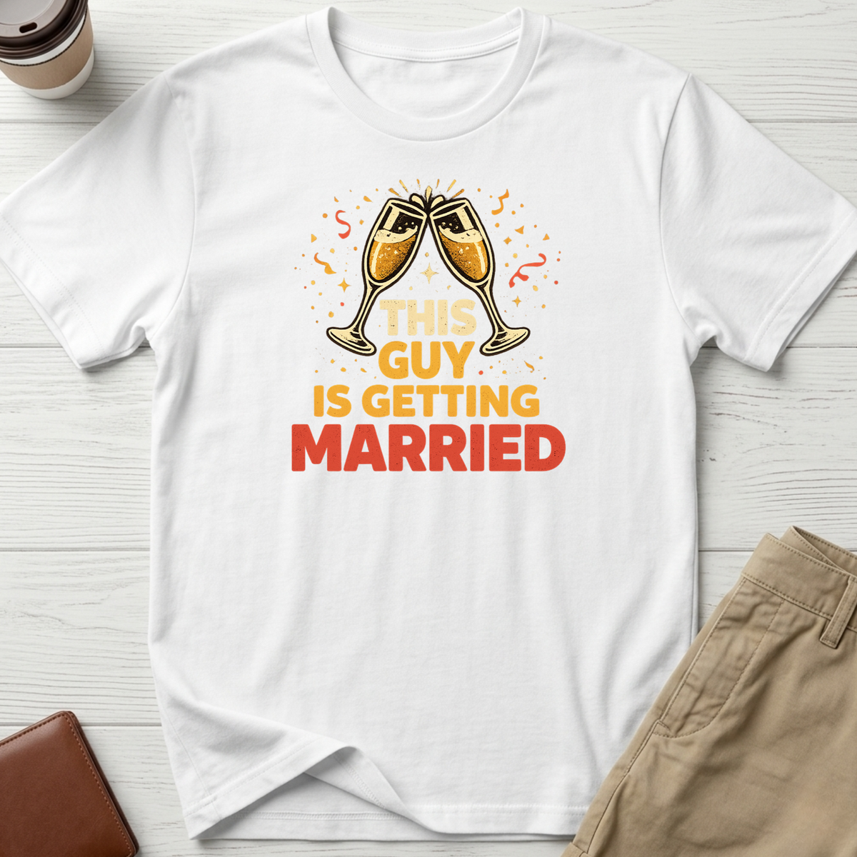 This Guy Is Getting Married graphic t-shirt featuring champagne glasses and bold celebration typography on a white unisex tee.