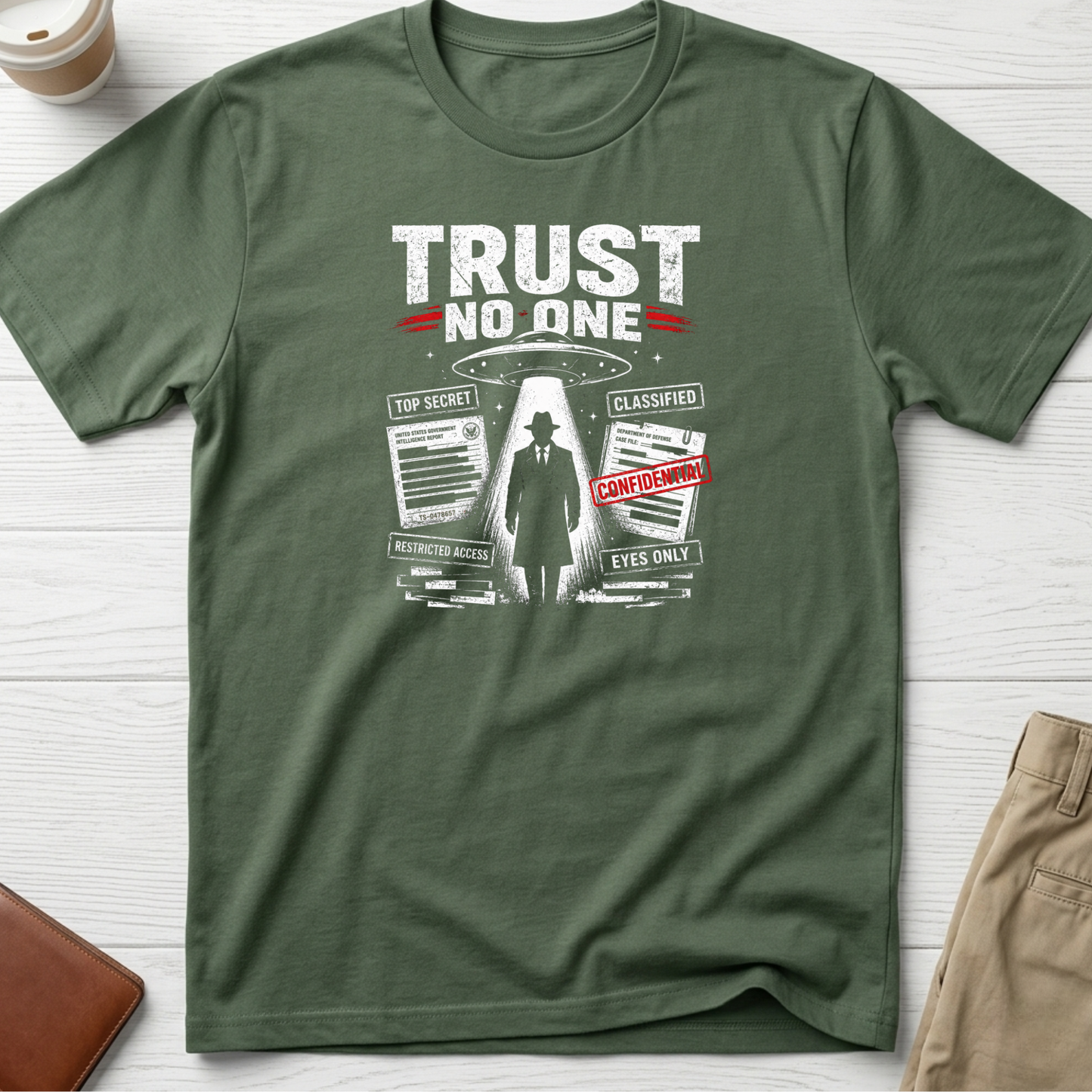 Trust No One graphic t-shirt featuring UFO abduction artwork, classified documents and conspiracy-inspired design on green unisex tee.