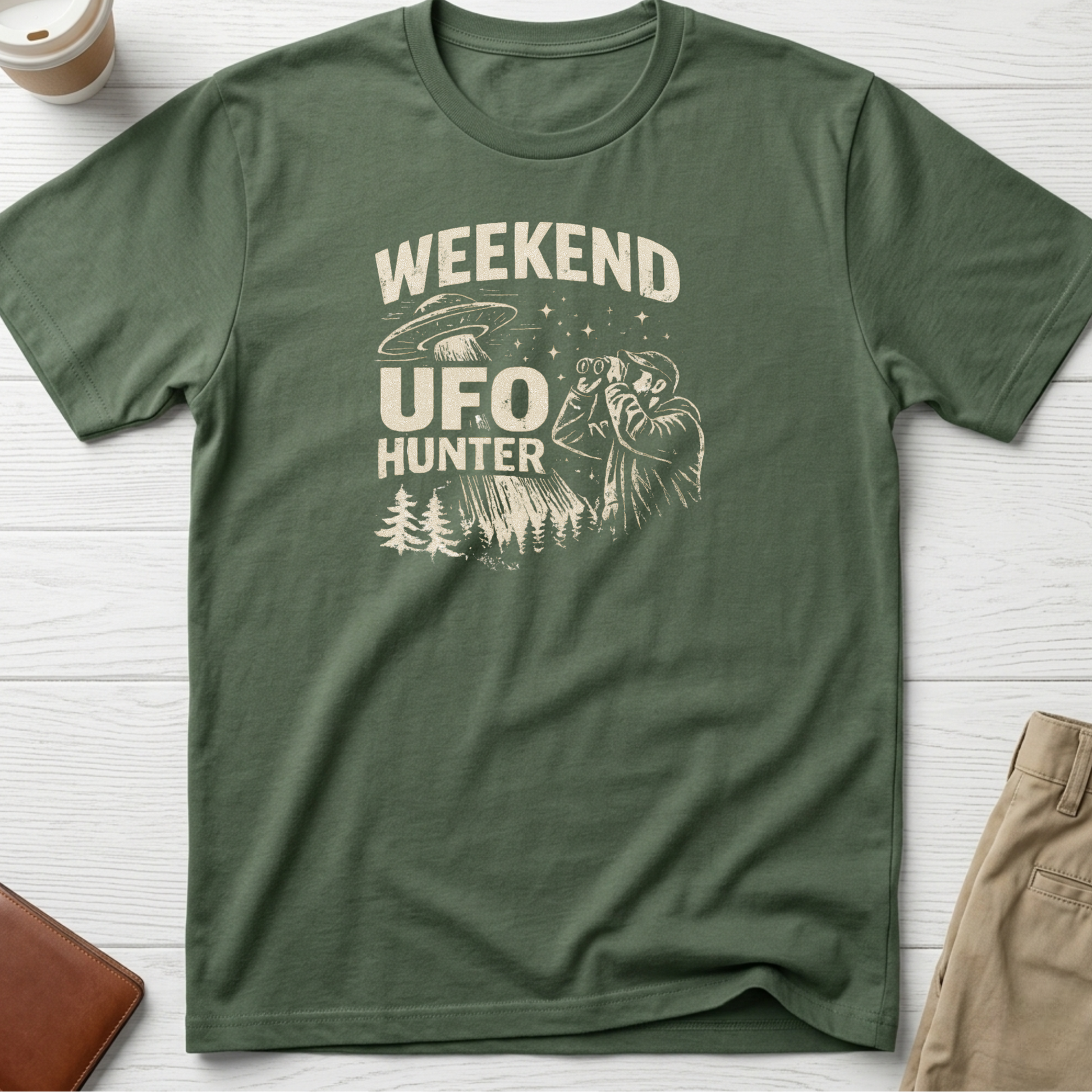 Weekend UFO Hunter funny graphic t-shirt featuring vintage flying saucer artwork and alien hunter illustration on green unisex tee.
