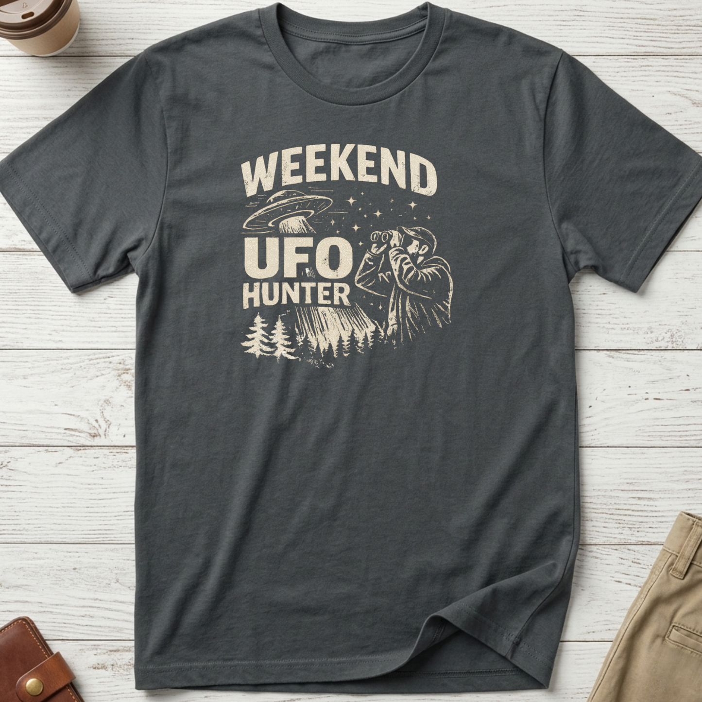 Weekend UFO Hunter funny graphic t-shirt featuring vintage flying saucer artwork and alien hunter illustration on charcoal unisex tee.