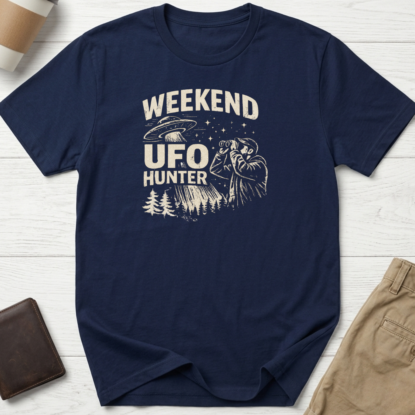 Weekend UFO Hunter funny graphic t-shirt featuring vintage flying saucer artwork and alien hunter illustration on navy blue unisex tee.