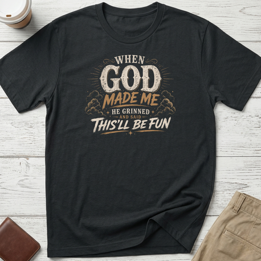 When God Made Me He Grinned And Said This'll Be Fun graphic t-shirt featuring distressed vintage typography on a black unisex tee.