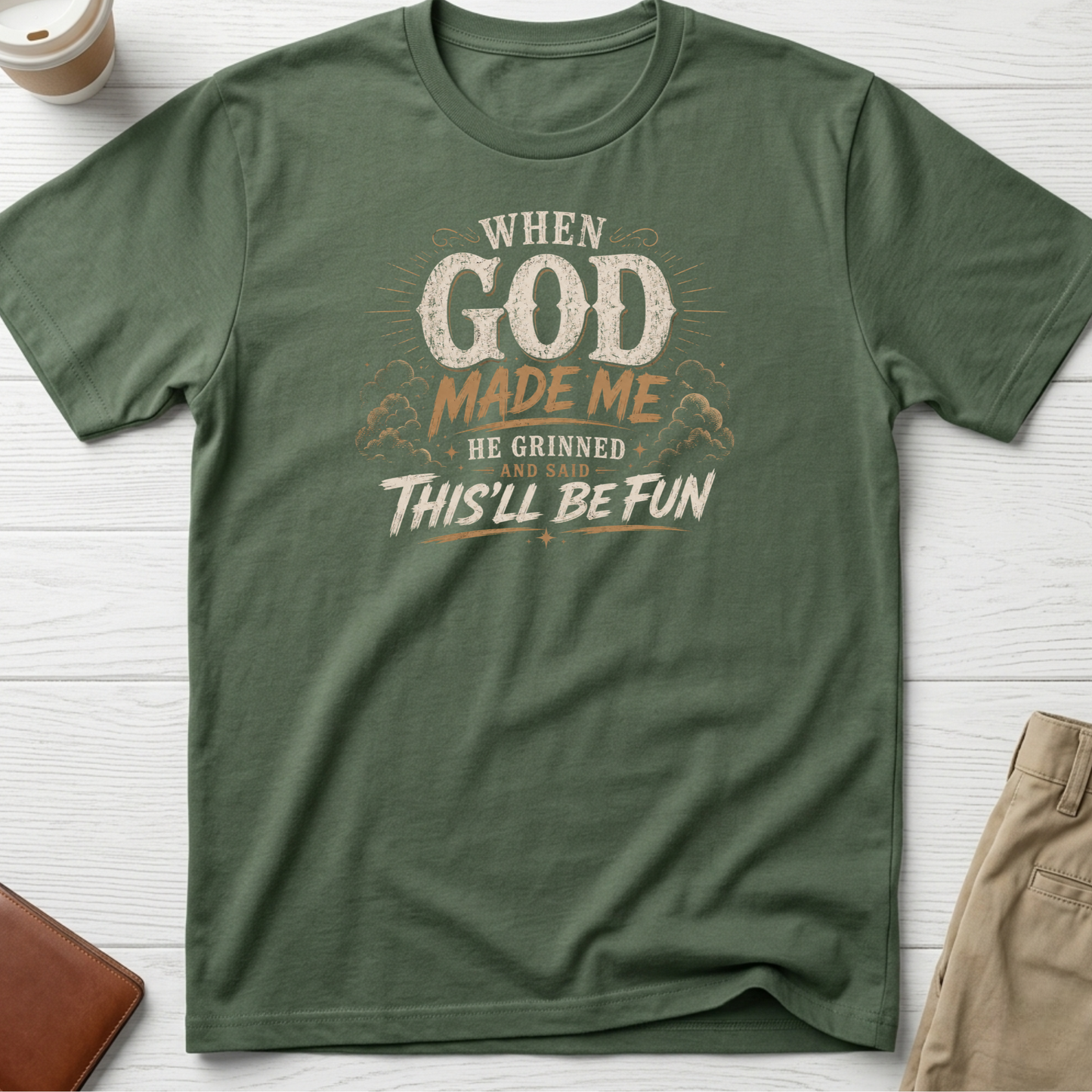 When God Made Me He Grinned And Said This'll Be Fun graphic t-shirt featuring distressed vintage typography on a green unisex tee.
