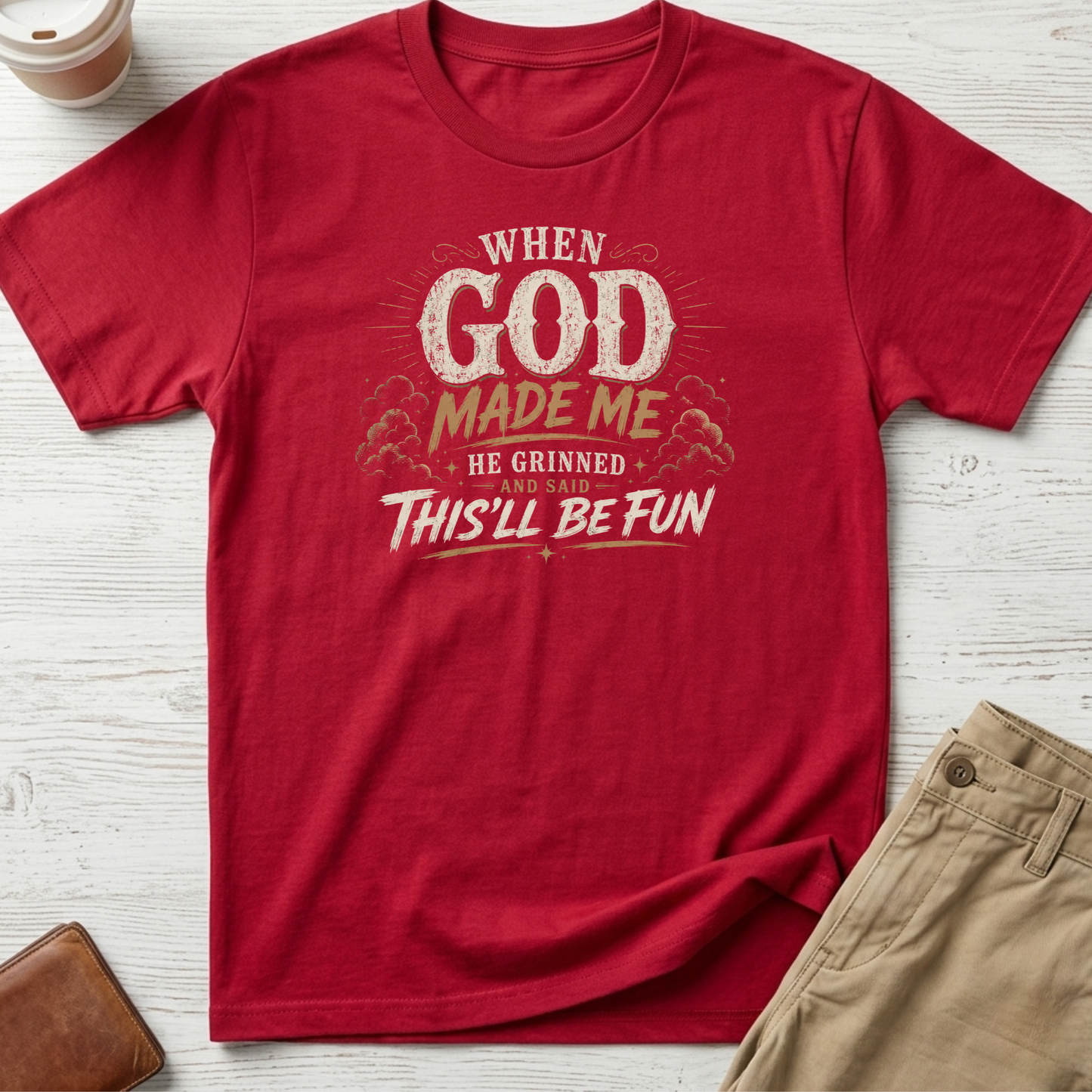 When God Made Me He Grinned And Said This'll Be Fun graphic t-shirt featuring distressed vintage typography on a red unisex tee.