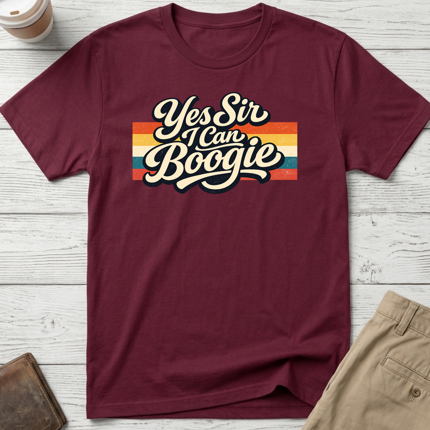 Yes Sir I Can Boogie retro graphic t-shirt featuring vintage typography with colourful 70s-inspired stripes on a maroon unisex tee.