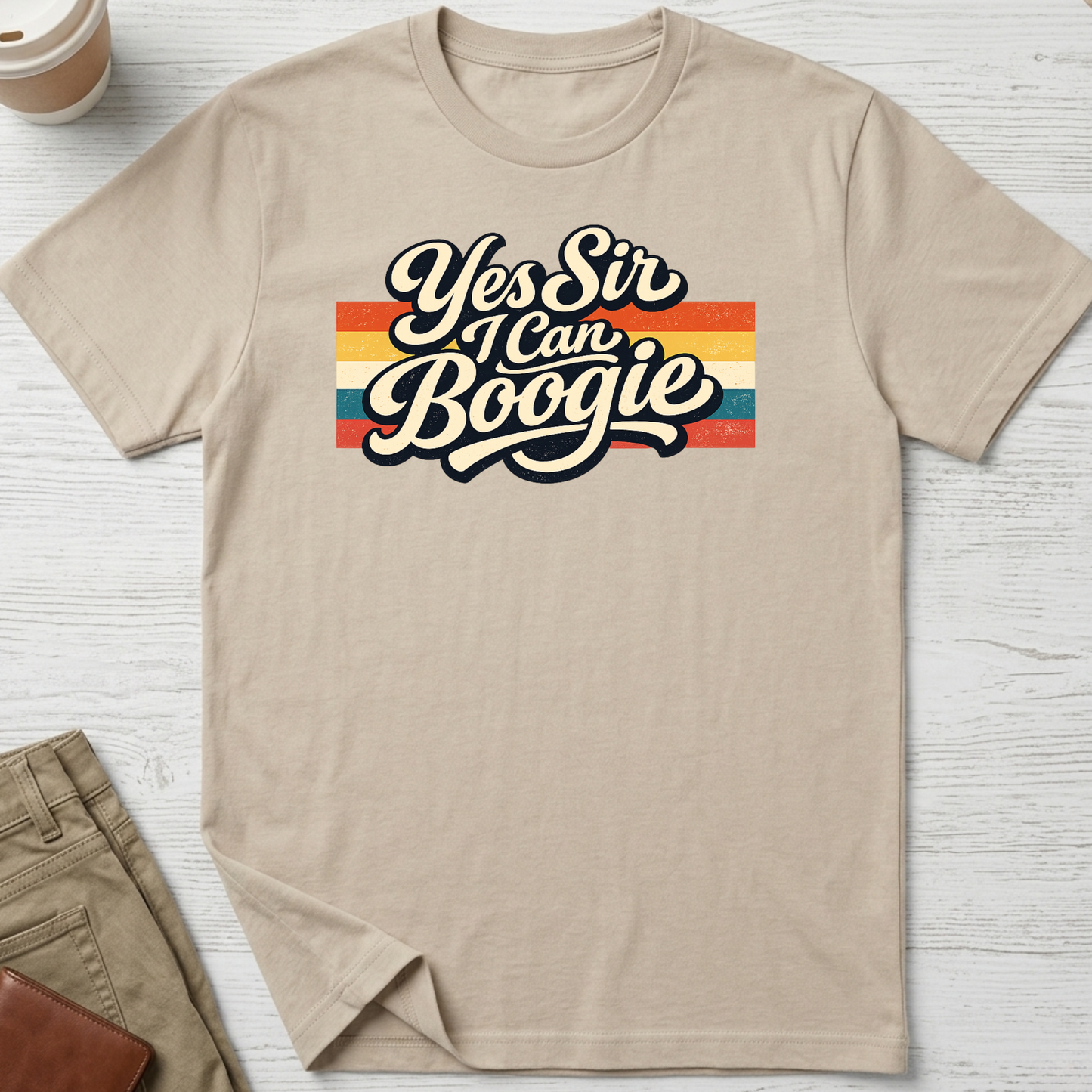 Yes Sir I Can Boogie retro graphic t-shirt featuring vintage typography with colourful 70s-inspired stripes on a sand unisex tee.